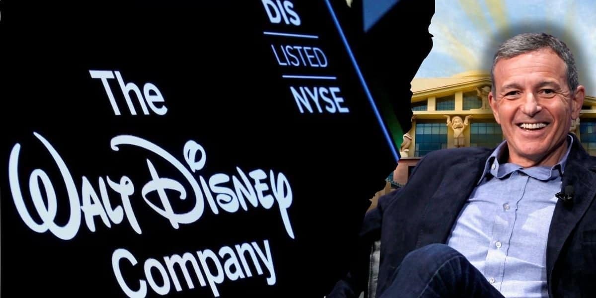 Bob Iger sitting confidently with the iconic Disney Company logo illuminating the background, representing the strong association between the executive and the esteemed entertainment conglomerate.