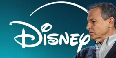 Bob Iger with a serious expression, beside the white disney logo on a blue gradient background.