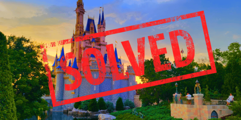Image of a scenic sunset at disney world with cinderella's castle in the background. the word "solved" is superimposed in bold red letters across the image.