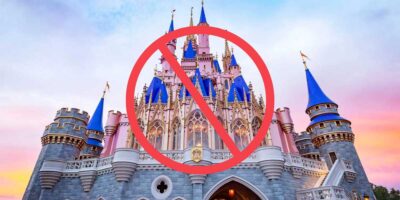 Magic Kingdom's iconic castle behind a red prohibitory sign.
