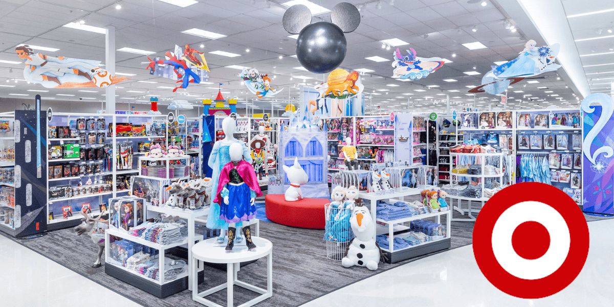 A vibrant target store toy section with disney-themed decorations, including character costumes and toys, under a large mickey mouse figure.