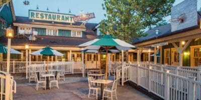 Outdoor dining area of Restaurantosaurus at Animal Kingdom as the lights come on at dusk.