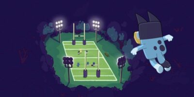 An animated scene features Bluey, a large blue dog, with a camera flying over a brightly lit football field at night. Two smaller dogs play on the field surrounded by goalposts and trees, bathed in the glow of floodlights.