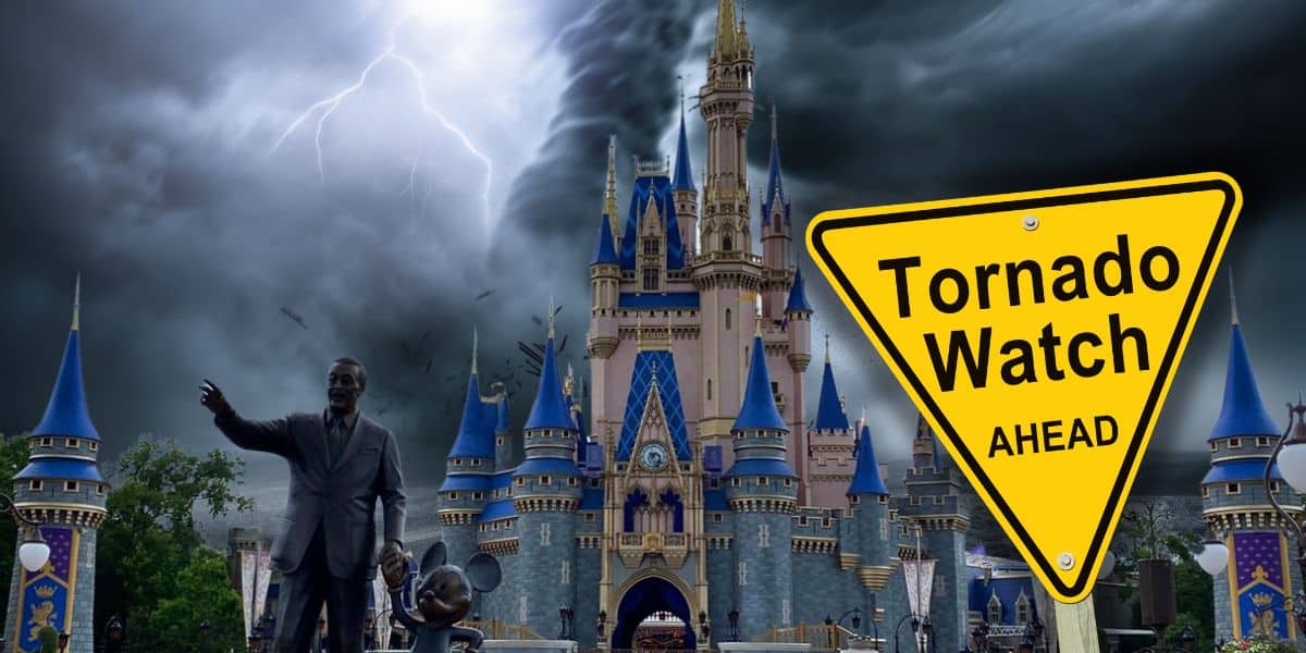A dark, stormy sky with lightning looms over a fairy tale castle. A yellow road sign in the foreground reads "Tornado Warning Ahead," contrasting with the cheerful statue of a man and a mouse character nearby, hinting at closed attractions at Disney World due to the severe weather.