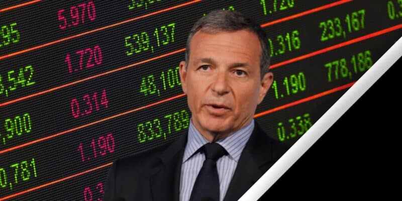 Disney CEO Bob Iger in front of a negative-performance stock price ticker.
