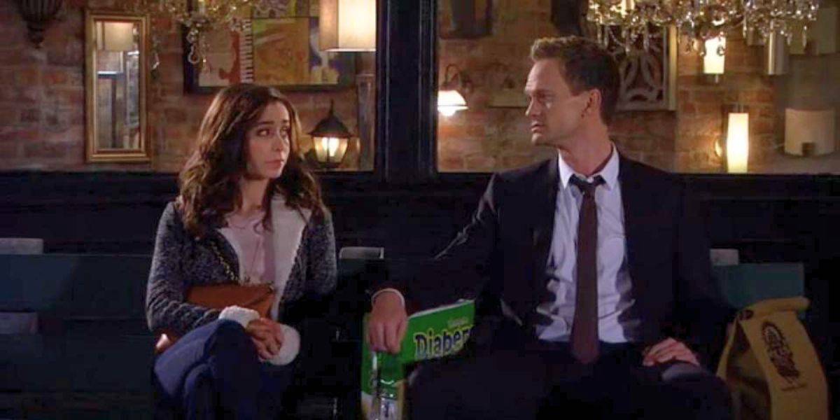 Cristin Milioti as Tracy (left) having a conversation with Neil Patrick Harris (right) as Barney Stinson, sitting on a bench and looking at each other.