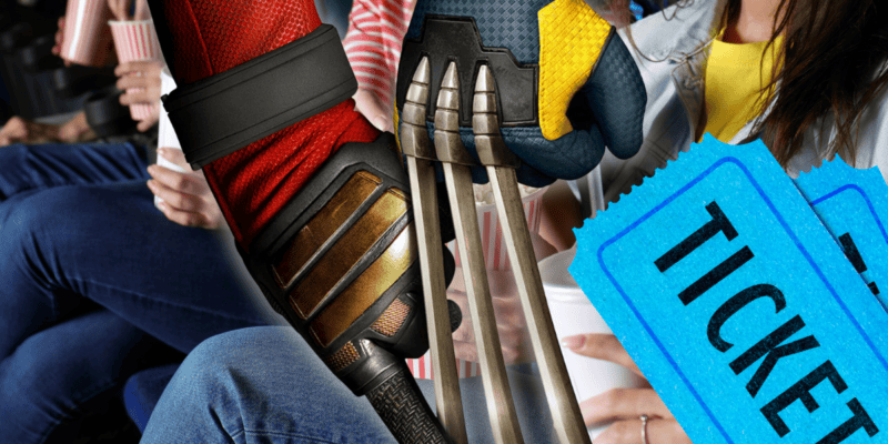 A close-up of two costumed hands, one with Wolverine's claws and the other with Deadpool's red glove, intertwined. In the background, people are seated holding popcorn and drinks, suggesting a movie theater setting. There are two blue tickets on the right side of the image. Don't Miss Out: Showtimes Officially Added for "Deadpool & Wolverine"