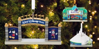 The image shows three Disney-themed Christmas ornaments hanging on a tree. One features the entrance to Walt Disney World, another depicts the It's a Small World ride, and the third showcases the Space Mountain attraction in perfect holiday Auto Draft style.