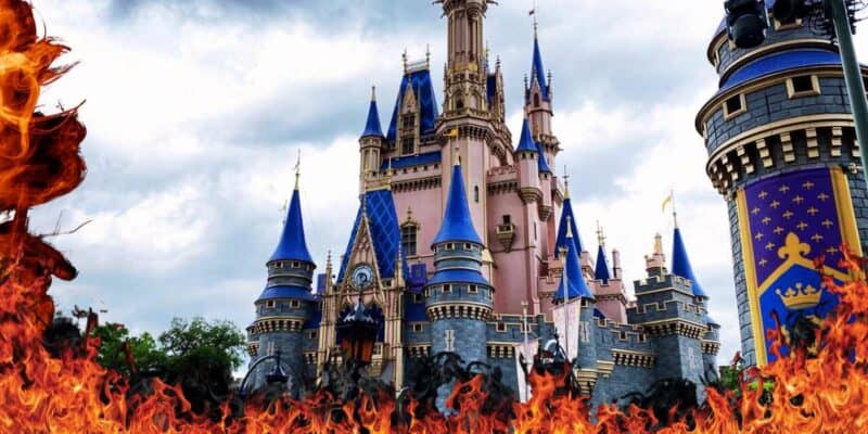 A dramatic image of a Cinderella Castle, surrounded by vibrant flames at the foreground under a cloudy sky.