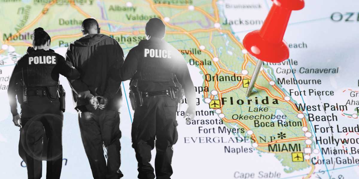 Two police officers, viewed from behind, standing before a vibrant map of Florida highlighting Orange County with a red pin marking a location.