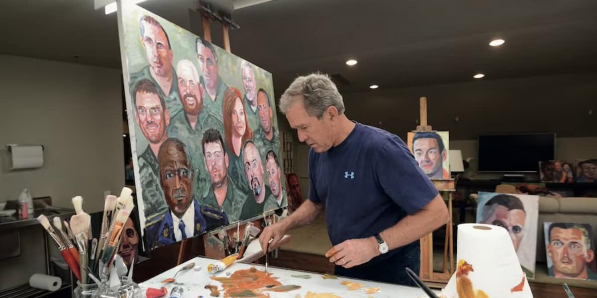 A man paints a large canvas filled with various expressive portraits in a studio, surrounded by brushes and paint palettes, despite news of the Disney World closure.