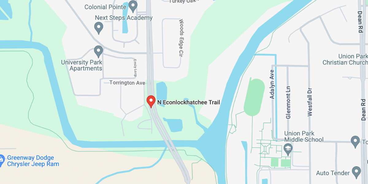 A map highlighting Econlockhatchee Trail in Orange County with nearby roads, a river, and surrounding local amenities including schools and an auto park.