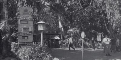 A black and white photo of cast members standing in Adventureland.