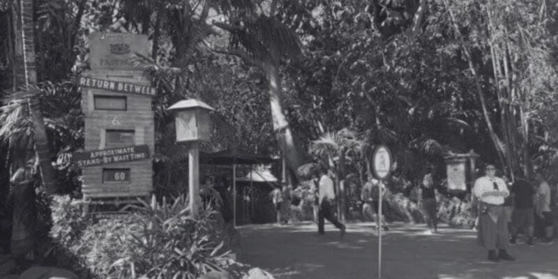 A black and white photo of cast members standing in Adventureland.
