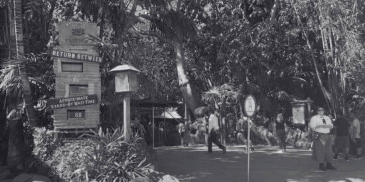 A black and white photo of cast members standing in Adventureland.