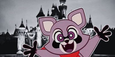 A cheerful, cartoon-style raccoon character with big, expressive eyes and a wide open mouth is waving its arms. The background features a grayscale image of Indigo Park's whimsical castle with towers and flags, reminiscent of a fairy tale or theme park setting.