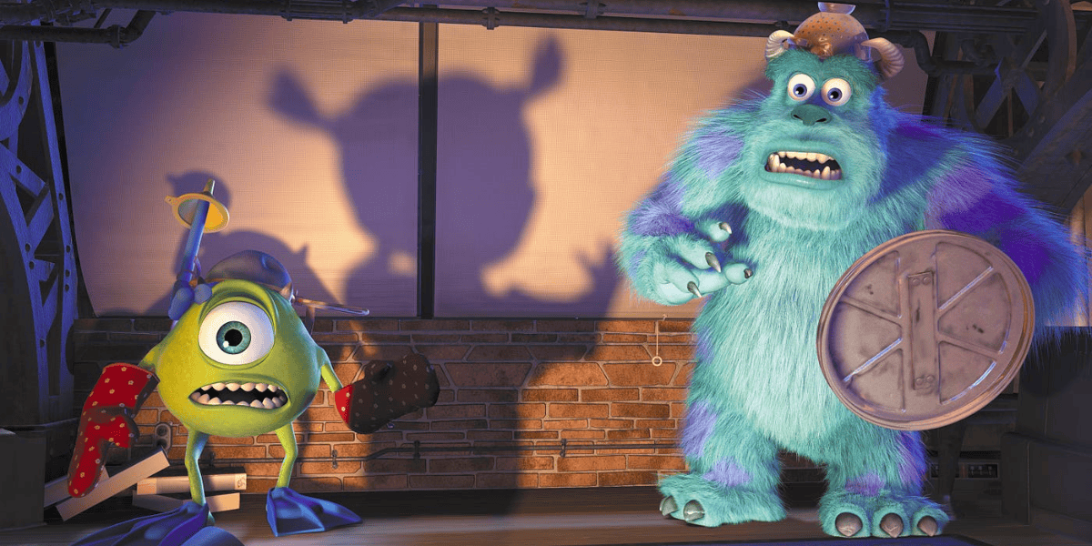 Monsters Inc. characters Mike and Sulley appear startled in a scene with a stage and brick background, projecting expressive shadows. Mike holds a brown stick, while Sulley clutches a toddler's closet
