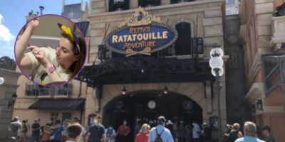 A girl writes on her arm with a sharpie in the foreground of an image of the entrance to Remy's Ratatouille Adventure.