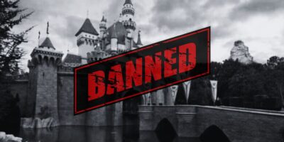 A black and white photo of Sleeping Beauty Castle at Disneyland Park. The word "banned" is added in the foreground, referencing suggested filming and social media bans at Disney parks.