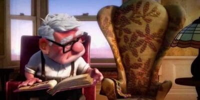 An elderly animated character wearing glasses reads a book intently, sitting in a cozy, patterned armchair by a window with sunlight filtering through.