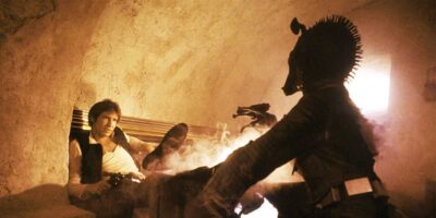 A man in a vest, sitting back with a blaster, faces an alien with a spiked head in a dimly lit, smoky setting reminiscent of a Star Wars cantina. The scene suggests tension and an impending confrontation.