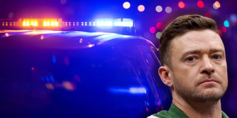 Justin Timberlake looks into the camera with a serious expression. In the background, vehicle lights are flashing red and blue, suggesting a police or emergency situation, possibly related to drunk driving or taking someone into custody.