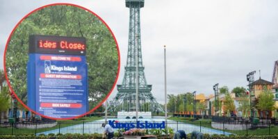 An image showcases a view of Kings Island, an amusement park. The park features a replica of the Eiffel Tower in the center. An overlay highlights a sign, which reads "Rides Closed," providing guest information and safety guidelines.