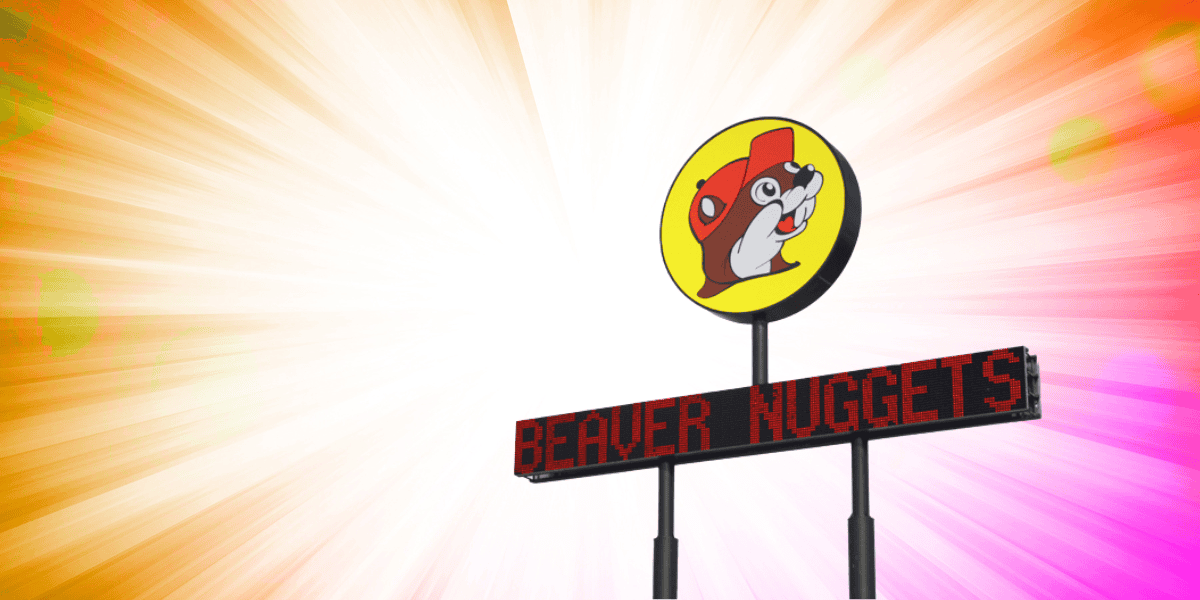 A round sign with a cartoon beaver wearing a red hat, and the LED display reads "BEAVER NUGGETS" on a pole. The background, inspired by the world's largest Buc-ee's, has a burst of bright, colorful lights with warm tones of orange, pink, and yellow.