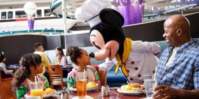 Mickey Mouse interacts with dining guests at Chef Mickey's