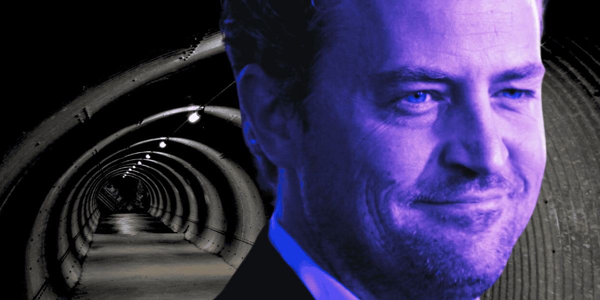 A man with a slight smile is superimposed over the image of a dimly lit tunnel. The man’s face is tinted blue, and he has light-colored eyes and short hair. The tunnel, reminiscent of something from a Matthew Perry drama, has a curved metallic structure with small lights hanging from the ceiling.