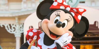Minnie Mouse, dressed in her classic red and white polka-dot dress and matching bow, poses at Disneyland