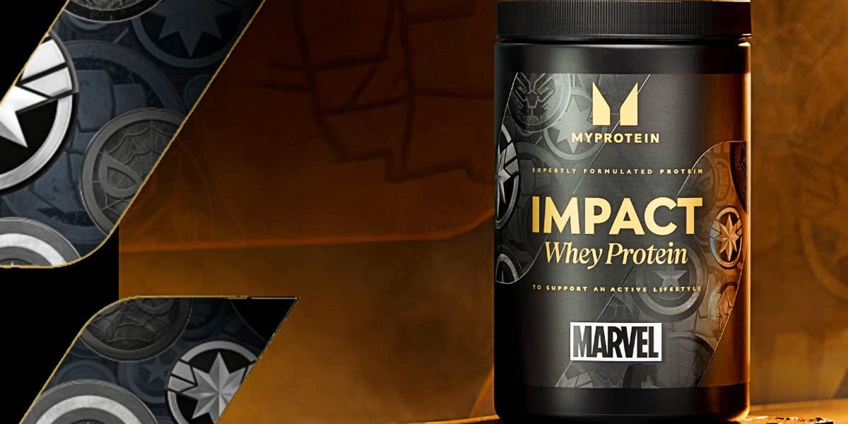 A container of MyProtein Impact Whey Protein with Marvel branding is displayed against a background featuring various Marvel superhero logos. The black and gold label emphasizes its purpose to support an active lifestyle.
