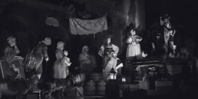 The auction scene on the Pirates of the Caribbean ride shown in black and white.