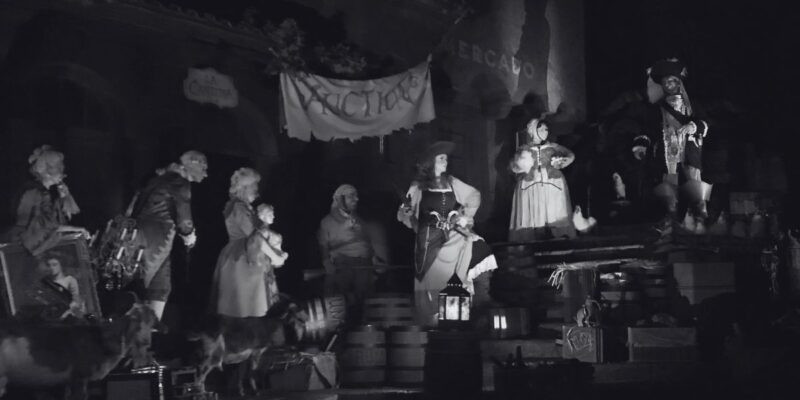 The auction scene on the Pirates of the Caribbean ride shown in black and white.