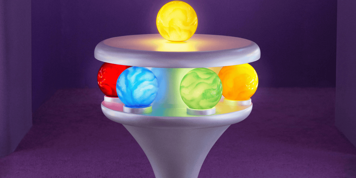 A futuristic pedestal display features six colorful, illuminated orbs. One yellow orb sits on top, while the other five (red, blue, green, yellow, and purple) are embedded around its edge, evenly spaced. The background is a softly lit, purple space.