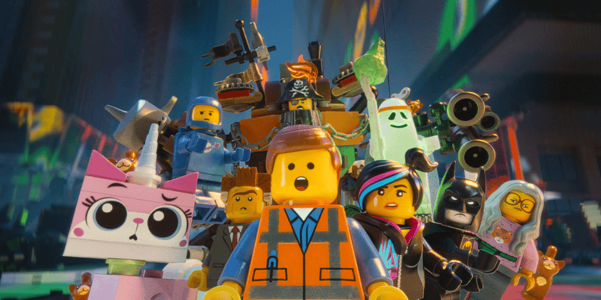 A group of animated LEGO characters stand together. Central is a character in an orange vest with a surprised expression. Surrounding them are a cat, a pirate, a construction worker, and an alien—all seemingly discussing the recent LEGO theft and the arrests that followed.