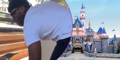 A person lifting a table, Sleeping Beauty Castle at Disneyland.