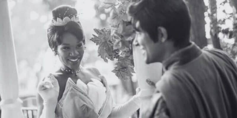 Princess Tiana and Prince Naveen smiling on the Liberty Belle at Magic Kingdom. The photo is in black & white.