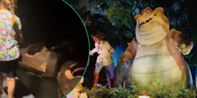 Guests evacuating Tiana's Bayou Adventure pictured next to Princess Tiana and Louis animatronics on the ride.