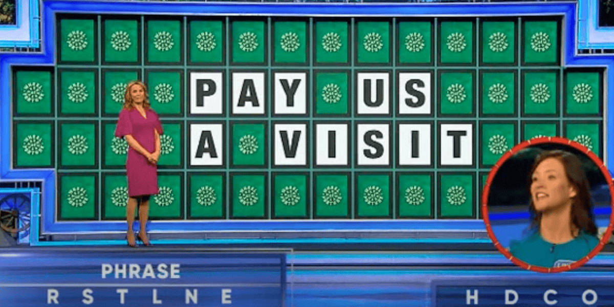 A woman in a purple dress stands beside a large game board displaying the phrase "PAY US A VISIT." Nearby, another woman in a green top is seen smiling in a red inset circle. The letters "RSTLNE" and "HDCO" are displayed at the bottom as given letters for the puzzle in this wild 43-year tradition.
