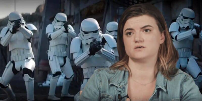 A woman wearing a denim jacket is in the foreground, speaking. In the background, a group of stormtroopers from Star Wars is seen aiming their weapons. The scene juxtaposes a real person with fictional characters from The Acolyte in the Star Wars franchise.