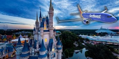 A blue Southwest Airlines plane flies over a fairy-tale Disney castle at sunset, with lush greenery and park rides visible in the background. The scene captures a whimsical juxtaposition of aviation and a magical theme park setting.