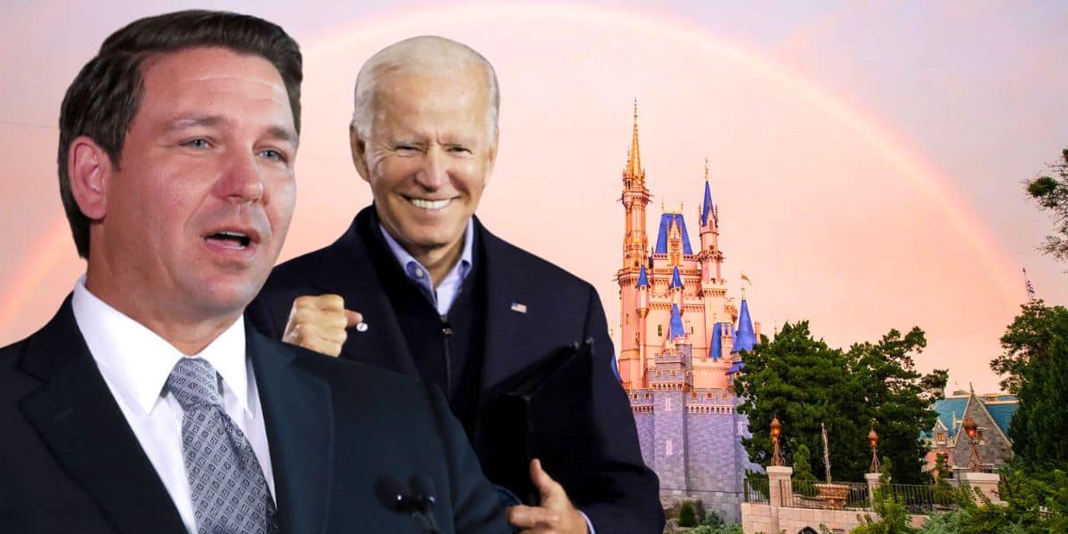 A composite image showing two men in front of a Disney castle with a rainbow in the background. The man on the left is speaking, wearing a suit and tie. The man on the right is smiling and raising his fist, also in a suit. Trees are visible in the foreground.