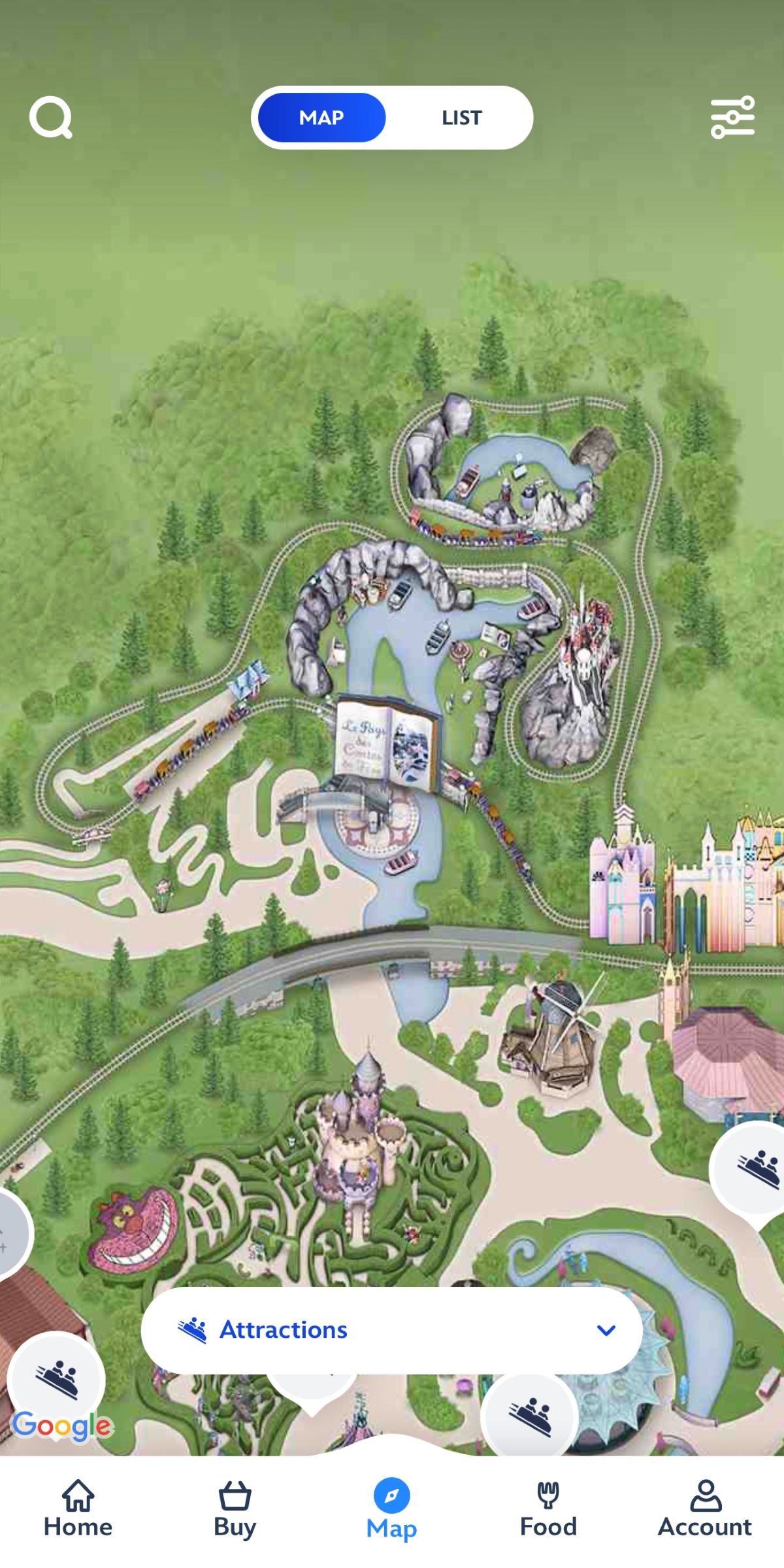 A detailed map of the Disney park with various attractions and green areas. The map features winding pathways, rides, themed buildings, and icons at the bottom like "Home," "Buy," "Map," "Food," and "Account." An "Attractions" label is highlighted.In the screenshot, the iconic Disney attractions Casey Jr. – le Petit Train du Cirque and Le Pays des Contes de Fées have been erased from the park