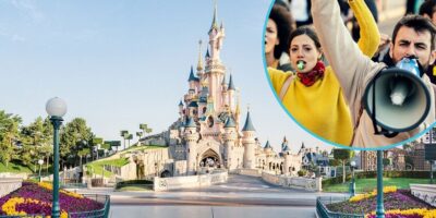The image shows an empty pathway leading to a castle at a Disneyland park. An inset photo displays two protesters, one with a yellow scarf blowing into a whistle and another shouting into a megaphone, set against a street protest scene.