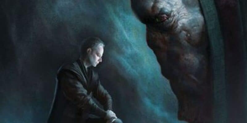 A person dressed in dark, medieval-style clothing kneels in a dimly lit cavern. They hold a sword, head bowed as if in deep thought or prayer. A large, shadowy, and menacing creature with red eyes looms in the background, creating a tense atmosphere.