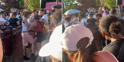 Two images depict a bustling scene at a Six Flags amusement park. In the first, a guest in pink shorts pushes a woman in an orange top. The second image captures a crowd gathering, with some looking concerned and others snapping photos.