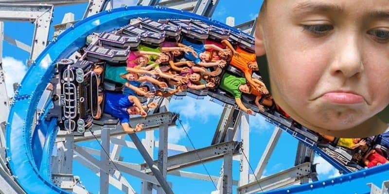 Six Flags rollercoaster with a sad child framed next to it