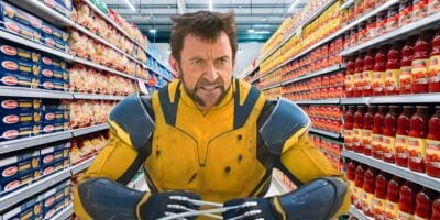 A man in a yellow and blue superhero costume is standing in a grocery store aisle, surrounded by shelves stocked with various products. He appears tense and has metal claws extended from his hands.