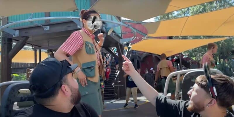 A YouTuber interacts with a cast member as he gets kicked off of Grizzly River Run at Disney California Adventure Park.